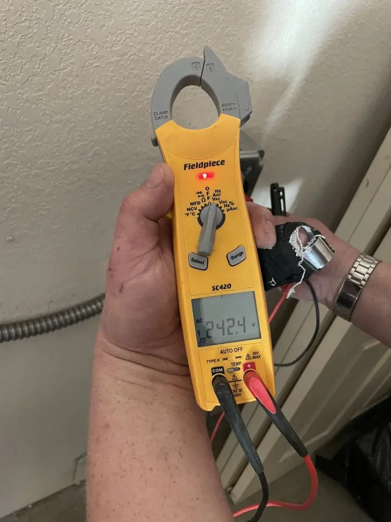 Voltage testing with clamp meter during Outlet Installation in Delafield